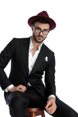 business man sitting with resting hand and staring at camera