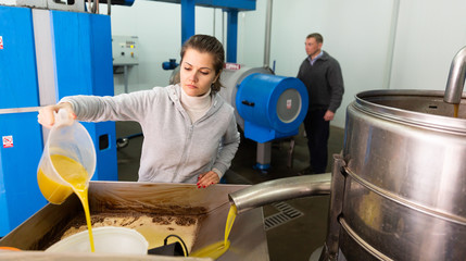 Woman controlling process of oil decanting