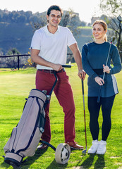Obraz premium Man and woman golf partners ready to enjoy game