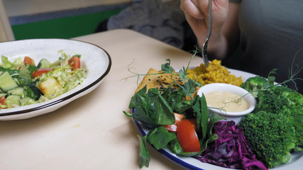 woman eating in vegetarian restaurants healthy food