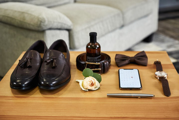 different accessories of a businessman for creating a style of a people lie on a wooden background