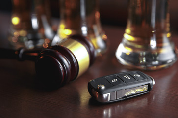 Fototapeta na wymiar Drinking and driving concept. Car key on a wooden table, pub background