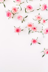 Floral composition with pink rose flower buds and leaves pattern on white background. Flatlay, top view.