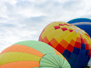 Fototapeta premium Balloons on the ground. Balloonists prepare the balloons for flight. Festival of aeronautics.