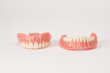 False prostheses. Dental hygienist checkup concept. Full removable plastic denture of the lower jaw.