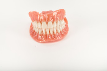 False prostheses. Dental hygienist checkup concept. Full removable plastic denture of the lower jaw.