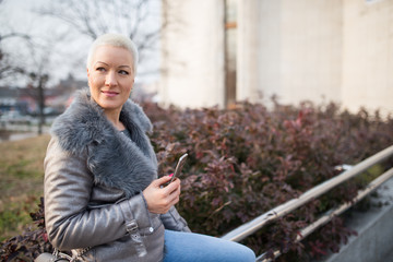 Woman on the street uses a cellphone