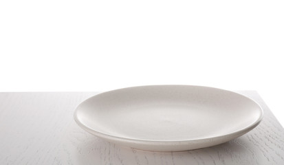 Clean empty plate on wooden table against white background