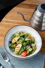 Halloumi cheese salad with mixed greens and tomatoes top view
