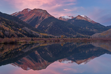 Autumn landscape at dawn of Crystal Lake with reflections in calm water, San Juan Mountains, Colorado, USA