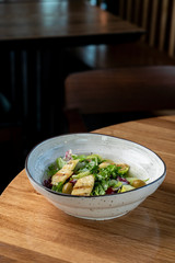 Halloumi cheese salad with mixed greens and tomatoes top view