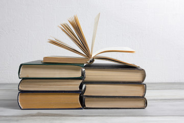 Open book, hardback books on wooden table. Back to school. Copy space