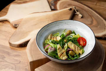 Halloumi cheese salad with mixed greens and tomatoes top view