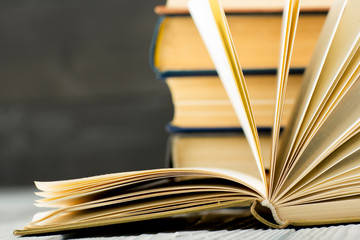 Open book, hardback books on wooden table. Back to school. Copy space