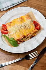 Cannelloni stuffed with turkey and vegetables, with melted cheddar and mozzarella cheese