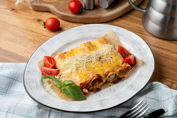 Cannelloni stuffed with turkey and vegetables, with melted cheddar and mozzarella cheese