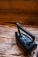 old traditional iron on wooden surface