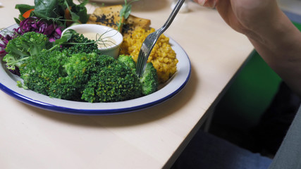 woman eating in vegetarian restaurants healthy food