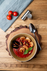 Hot and spicy tomato soup with king prawns and scallops and garlic