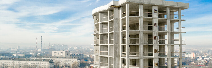 Panorama of Aerial view of concrete frame of tall apartment building under construction in a city