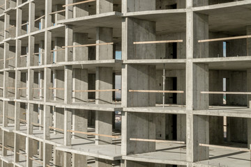 Aerial view of concrete frame of tall apartment building under construction in a city