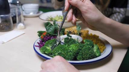 woman eating in vegetarian restaurants healthy food