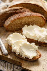 A sourdough bread sandwich with cottage cheese, close-up view. Delicious and healthy vegetarian breakfast