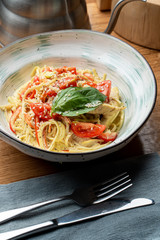 Italian spaghetti with chicken breast, creamy sauce and cheese close up