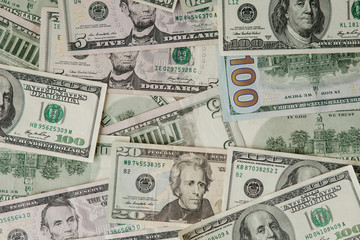 background from scattered dollar banknotes as abstract seamless. toned image