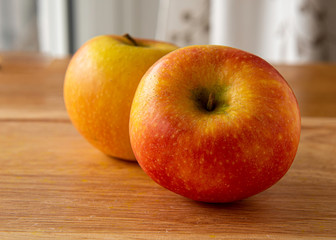 Red apple close up on a wooden background