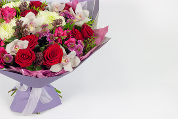 Fresh arrangement of vibrant flowers close-up work florist light background