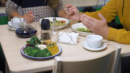 couple man and woman eating in vegetarian restaurants healthy food