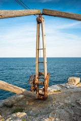 Fototapeta premium Portland Bill with the corroding remains of a disused quarry hoist on the Isle of Portland, Dorset. England. UK.