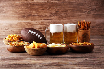 Chips, salty snacks, football and Beer on a table. Great for Bowl Game snack projects.