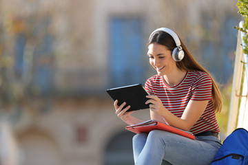 Happy student with headphones and tablet e learning