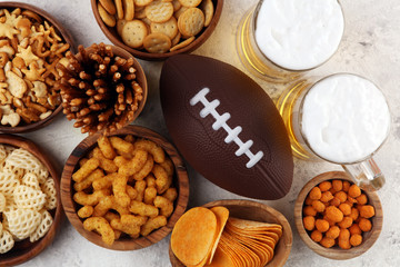 Chips, salty snacks, football and Beer on a table. Great for Bowl Game snack projects.
