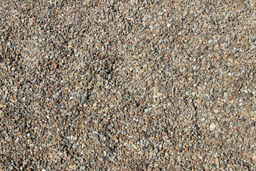 Marble texture. The background is a palyned plate. A product made of stone. Fragments of small stones. Smooth surface with a glossy sheen reflecting light. Soft warm honeyed tone. Orange color