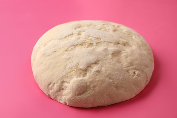 Raw dough for pastries on pink background, closeup