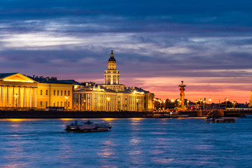 Fototapeta na wymiar Petersburg during the white nights. Summer trip to Russia. Vasilievsky island. Rivers Of St. Petersburg. Pleasure boats on the Neva. Tourists admire the white nights. Rostral column.