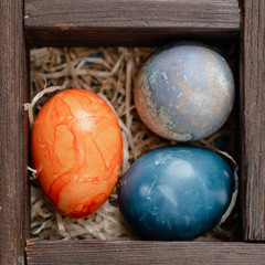Easter eggs in a box with straw