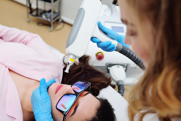 removal of tattoos, pigmentation, moles, vascular asterisks using a neodymium laser in a modern cosmetic dermatological clinic. Hardware cosmetology