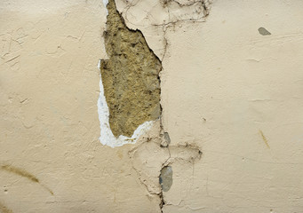 crack and crumbling beige stucco