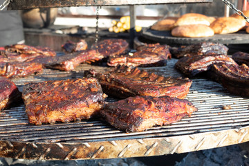 Close-up. Fried pork ribs lie on a large roasting pan.