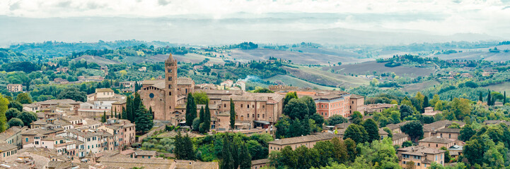 Fototapeta na wymiar Panoramic wide banner of Old Town of medieval city of Siena in the cloudy autumn day, Tuscany, Italy