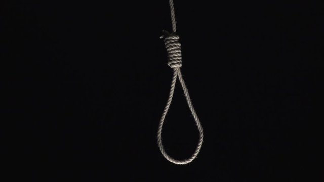 Rope noose hanging down on a Black background. Topics: Suicide, Mental Health, Depression