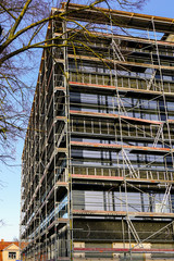 scaffolding arround the house to install thermal insulation of the apartment building facade