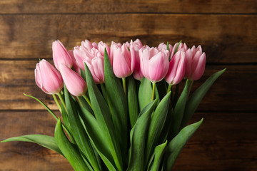 Beautiful pink spring tulips on wooden background
