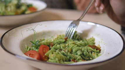 fashionable design food. vegetarian pasta with green sauce and cashew nuts