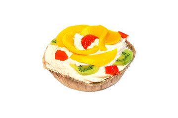 Homemade cream fruit cake isolated on a white background. Fresh and tasty cake with peach, strawberry and kiwi
