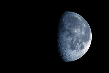 The moon is in a growing phase. On a dark background. Elements of this image were furnished by NASA.
